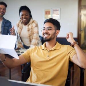 Success, celebration and students with results after exam in university. Goal achievement, education scholarship and group of people happy with friend with paper passing test and celebrating victory